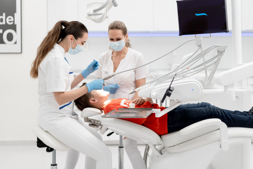 Professional dental team in consultation with patient in modern clinic setting